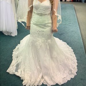 Never worn wedding dress, veil and tiara included
